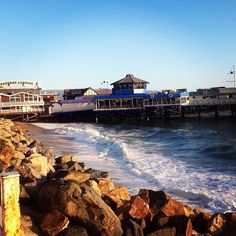 the beach is lined with rocks and houses