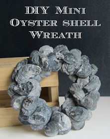 a wreath made out of rocks sitting in front of a blackboard with the words diy mini oyster shell wreath