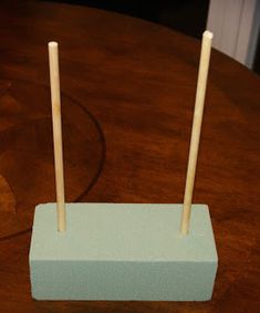 two toothpicks are placed on top of a wooden table