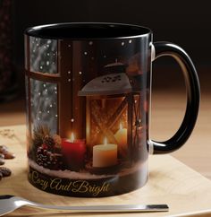 a coffee mug sitting on top of a wooden table next to a fork and knife