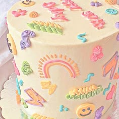 a white cake with lots of colorful decorations on it