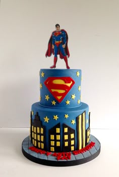 a blue cake with a superman figure on top