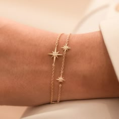 This delicate 14k yellow gold bracelet features an elegant North Star with elongated rays and set with a diamond. Suspended on fine gold chain, this handmade bracelet is from a new collection of Guiding Stars with designs inspired by our ever-popular True North charms. Made with recycled gold. Total diamond weight - 3pt. (F SI quality). Dower & Hall designs their jewellery to be worn and treasured. Here are a few simple guidelines to keep your jewellery looking its best: Perfume, skin and hair p Star Jewelry Bracelet, North Star Bracelet, Dainty Star Bracelet, Fine Gold Bracelet, Minimalistic Gold Jewelry, Elegant Gold Bracelet Simple, Dainty Charm Bracelet, Bracelet Ideas Gold, Dainty Bracelets Gold