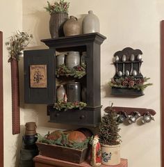 an old fashioned hutch with christmas decorations on the top and bottom shelf, along with other items