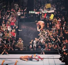 a wrestling match is being watched by fans