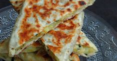 several quesadillas stacked on top of each other on a glass platter