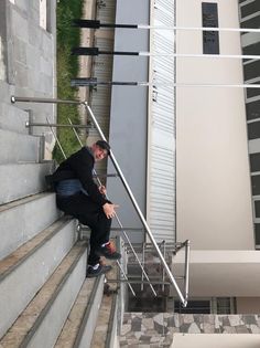 a man is sitting on the stairs outside