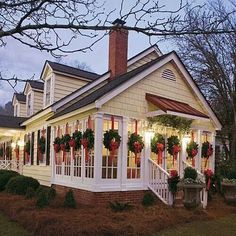 a house decorated for christmas with wreaths and lights