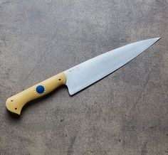 a yellow and blue knife laying on the ground