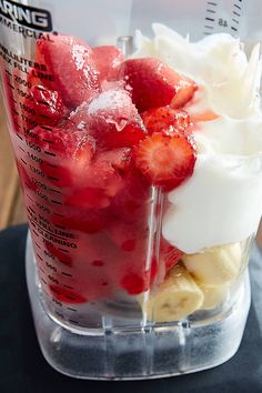 strawberries, bananas and cream in a blender