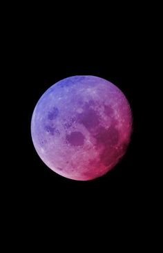 the full moon is seen in the dark sky with purple hues on its surface