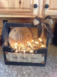 a wooden box filled with lights and a sign that says faith family friend on it