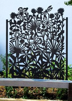 a metal screen sitting on top of a wooden bench