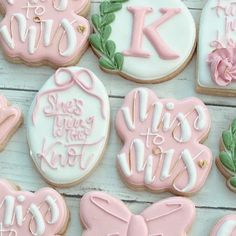 decorated cookies with pink and white frosting on a table