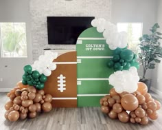 football themed balloon arch with balloons in the shape of an american football field and ball