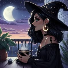 a woman wearing a witches hat holding a cup of coffee on a balcony at night