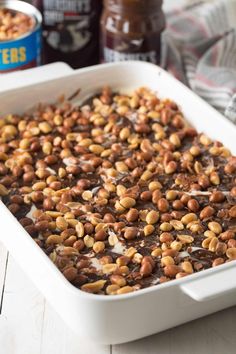 a white casserole dish filled with nuts and chocolate