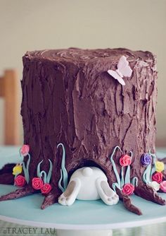 there is a chocolate cake with flowers on the top and decorations in the bottom layer