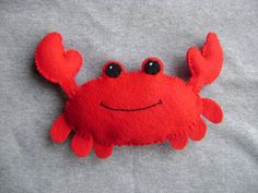 a close up of a red crab on a gray background