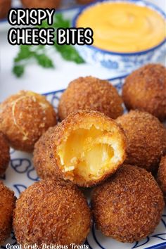 crispy cheese bites on a blue and white plate with dipping sauce in the background