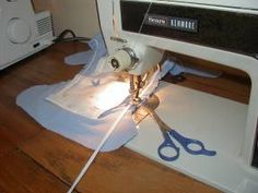 a white sewing machine sitting on top of a wooden floor