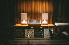 two lamps sitting on top of a sound board