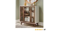 a wooden cabinet with glass doors in front of a mirror and clock on the wall