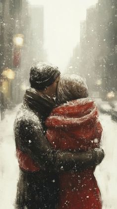 two people hugging each other on a snowy day in the city with buildings and street lights behind them