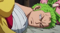 a man with green hair laying on top of a bed