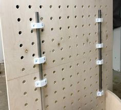 there are several pegboards on the wall with holes in them