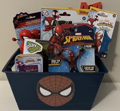 a toy box filled with spiderman toys