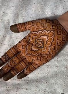 a person's hand with hennap on it, showing the intricate design