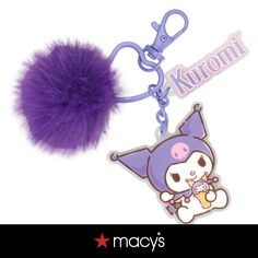 a purple key chain with a furry ball on it's end and an image of a