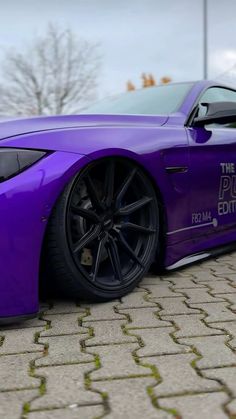 a purple sports car parked on the street