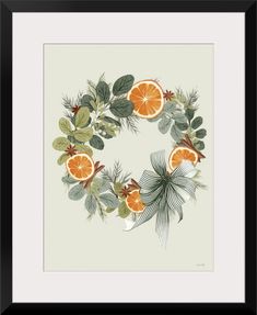 an orange wreath with leaves and pine cones on the front, framed in black frame