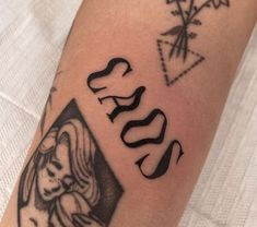 a close up of a person's arm with tattoos on it and the word jesus