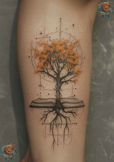 a tree with orange leaves on its roots and an open book in the shape of a cross