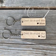 Comical reminder for the kids who are old enough to drive: "Don't do stupid shit" You can customize this wooden key chain to have 'hear' Mom, Dad or both Mom & Dad by selecting the correction option from drop down box below. Wooden keychain part measures 2.5" x 0.8" and is made of high quality maple plywood that has a clear seal on it. A 1 inch metal split key ring is attached. Please be aware that wood naturally has defects. Not every board is the same. There may be knots, wood grain, and natur Glowforge Crafts, Laser Keychain, Laser Creations, Xtool F1, Diy Laser Engraver, Spring Market, Engraving Ideas, Keychain Craft, Mom Keychain