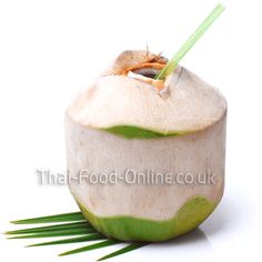 a coconut drink with green stems sticking out of it