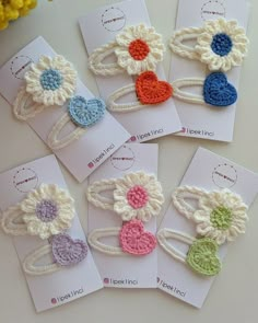 six crocheted hair clips with flowers on them