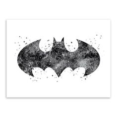 the batman symbol is shown in black and white, with splattered paint on it