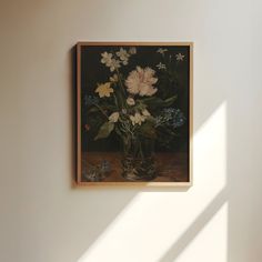 a painting hanging on the wall next to a vase filled with flowers