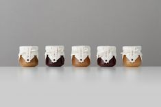 five small brown and white shoes sitting on top of each other