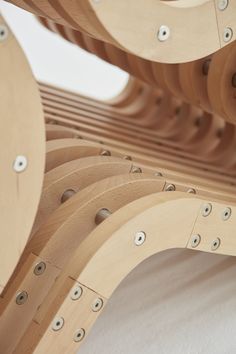 the wooden structure has holes in it and is made from plywood planks that have been cut into smaller circles