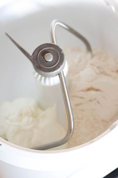 a mixer filled with white batter in a bowl