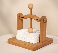 a stack of cloths sitting on top of a wooden stand