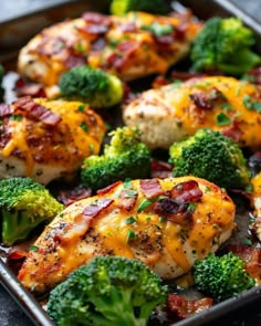 chicken and broccoli covered in cheese on a baking sheet