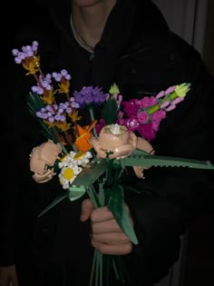 a person holding a bouquet of flowers in their hands