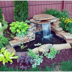 a small waterfall in the middle of a garden