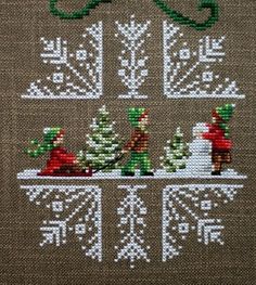 a cross stitch christmas scene with santa and snowmen in the middle, surrounded by evergreens